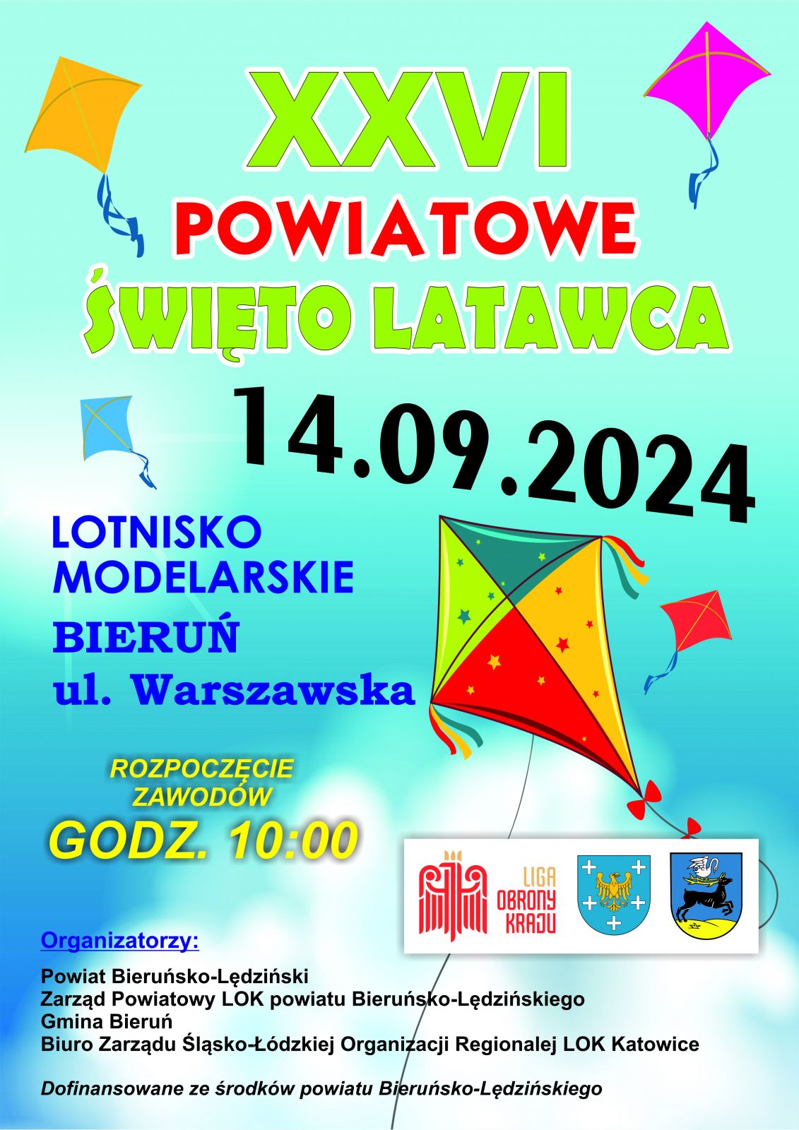 Plakat informacyjny w kolorze niebieskim, na środu napis informujący o zawodach raz grafika przedstawiająca kolorowy latawiec